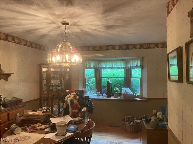 9439 Williams Rd, Diamond, OH 44412 - dining area with wallpapered walls, a chandelier, and wood finished floors