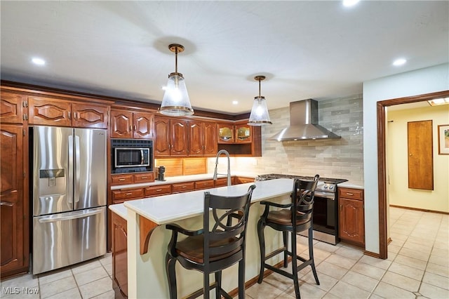 5074 Tall Timbers Dr, Richfield, OH 44286 - kitchen with appliances with stainless steel finishes, wall chimney range hood, light countertops, an island with sink, and recessed lighting