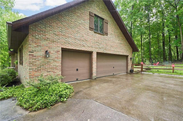 5074 Tall Timbers Dr, Richfield, OH 44286 - view of property exterior featuring brick siding, driveway, and a garage