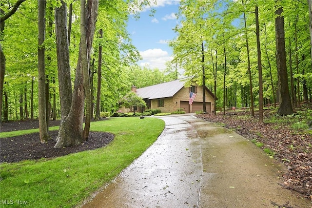 5074 Tall Timbers Dr, Richfield, OH 44286 - view of front of home featuring a garage, a front lawn, a chimney, and driveway