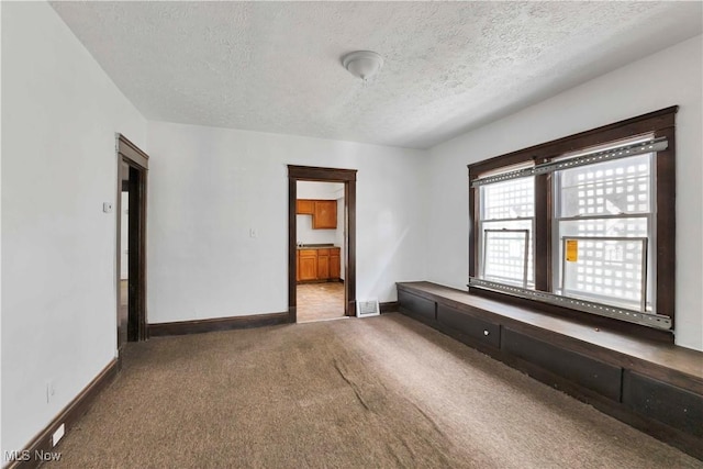851 Paxton Rd, Cleveland, OH 44108 - carpeted empty room featuring a textured ceiling and baseboards