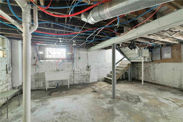 851 Paxton Rd, Cleveland, OH 44108 - basement featuring electric panel, stairway, and a sink