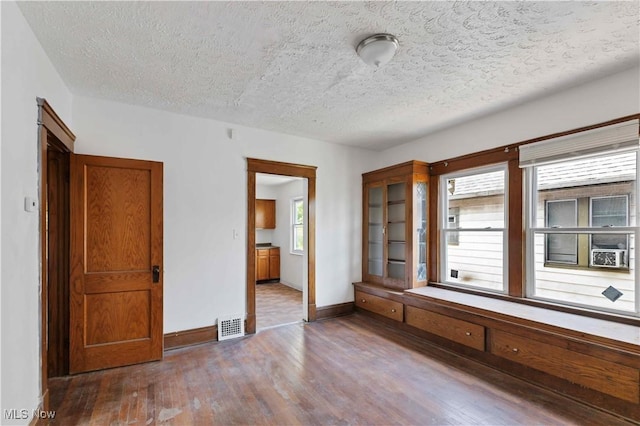 851 Paxton Rd, Cleveland, OH 44108 - unfurnished bedroom with wood finished floors, a textured ceiling, and baseboards