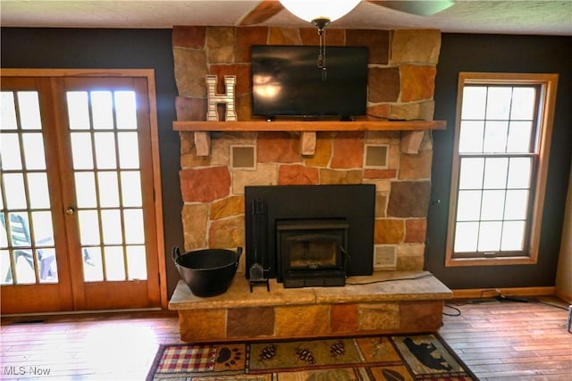5399 N Elyria Rd, West Salem, OH 44287 - detailed view of wood finished floors, french doors, baseboards, and a fireplace