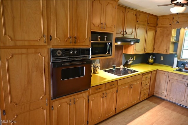 5399 N Elyria Rd, West Salem, OH 44287 - kitchen featuring wall oven, stainless steel microwave, black electric cooktop, light countertops, and under cabinet range hood
