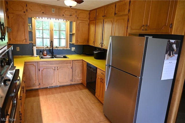 5399 N Elyria Rd, West Salem, OH 44287 - kitchen featuring freestanding refrigerator, black dishwasher, a sink, light countertops, and light wood-style flooring