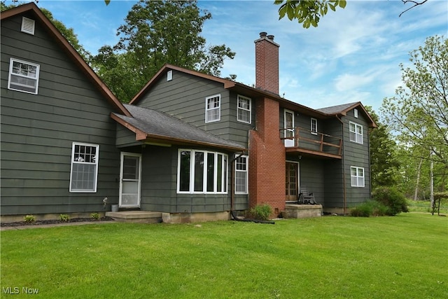 5399 N Elyria Rd, West Salem, OH 44287 - back of property featuring a chimney, a balcony, a yard, and a shingled roof