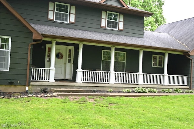 5399 N Elyria Rd, West Salem, OH 44287 - view of front facade with covered porch, a front yard, and a shingled roof