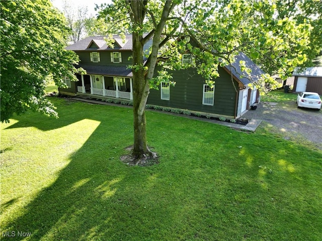 5399 N Elyria Rd, West Salem, OH 44287 - view of front of home with a porch, a front lawn, and a garage