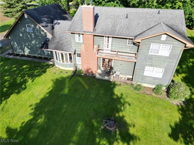 5399 N Elyria Rd, West Salem, OH 44287 - back of property with a chimney, a lawn, a balcony, a patio, and a shingled roof