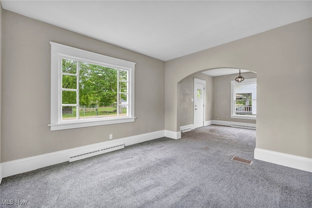 6567 S Pricetown Rd, Berlin Center, OH 44401 - carpeted spare room featuring arched walkways, a baseboard heating unit, healthy amount of natural light, and baseboards