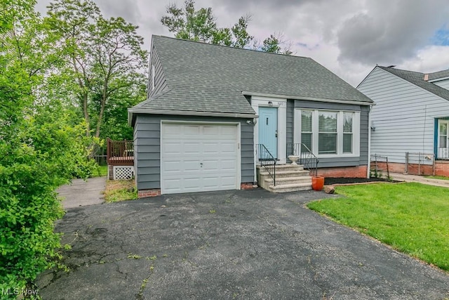 1620 S Taylor Rd, Cleveland Heights, OH 44118 - view of front of home featuring a garage, roof with shingles, asphalt driveway, and a front yard