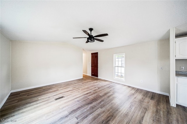 141 Marilyn Dr, Madison, OH 44057 - empty room featuring a ceiling fan, wood finished floors, lofted ceiling, and baseboards