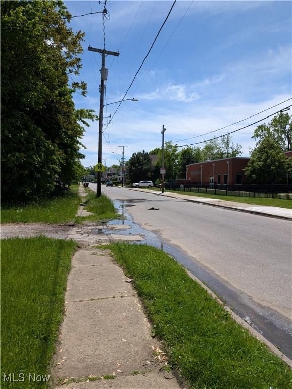1367 Clearaire Rd, Cleveland, OH 44110 - view of asphalt road featuring sidewalks, street lighting, and curbs