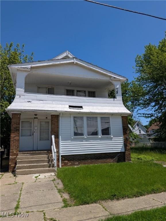 1367 Clearaire Rd, Cleveland, OH 44110 - view of front of house with a porch and brick siding