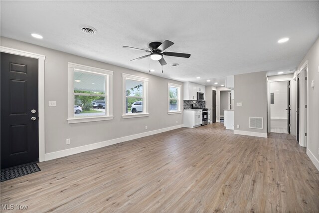 12364 Avalon Dr, Grafton, OH 44044 - unfurnished living room featuring a ceiling fan, light wood finished floors, baseboards, and recessed lighting