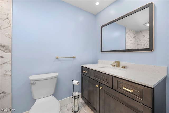 12364 Avalon Dr, Grafton, OH 44044 - bathroom featuring marble look tile flooring, baseboards, vanity, and toilet