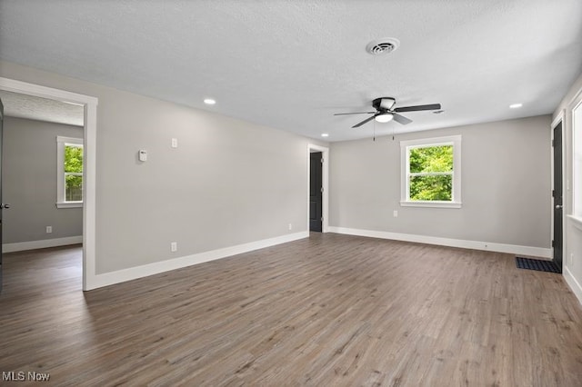 12364 Avalon Dr, Grafton, OH 44044 - unfurnished room featuring a ceiling fan, healthy amount of natural light, wood finished floors, baseboards, and a textured ceiling