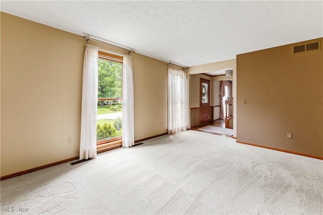 9852 Hocking St NW, Massillon, OH 44646 - unfurnished room with light colored carpet, baseboards, and a textured ceiling