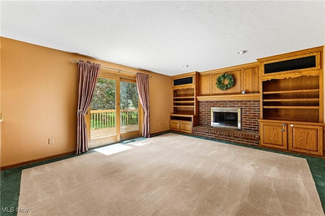 9852 Hocking St NW, Massillon, OH 44646 - unfurnished living room featuring light carpet, baseboards, a textured ceiling, and a fireplace