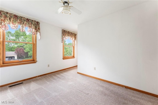 9852 Hocking St NW, Massillon, OH 44646 - unfurnished room with baseboards, carpet, and a ceiling fan