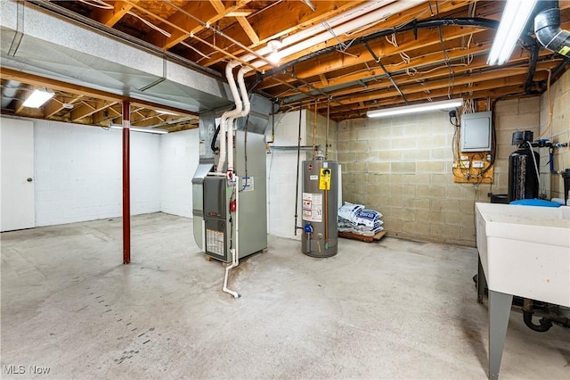9852 Hocking St NW, Massillon, OH 44646 - unfinished below grade area with gas water heater, heating unit, and concrete block wall