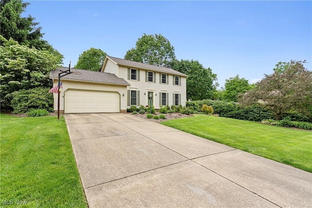 9852 Hocking St NW, Massillon, OH 44646 - colonial home with an attached garage, a front yard, and driveway