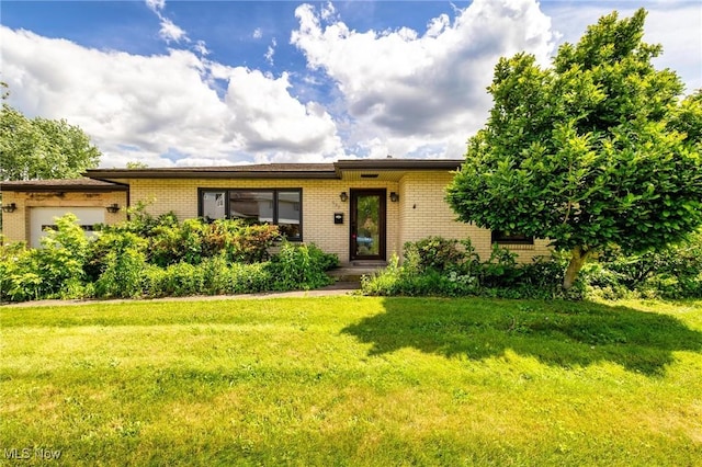 625 Henry St, Toronto, OH 43964 - ranch-style house with brick siding, an attached garage, and a front lawn