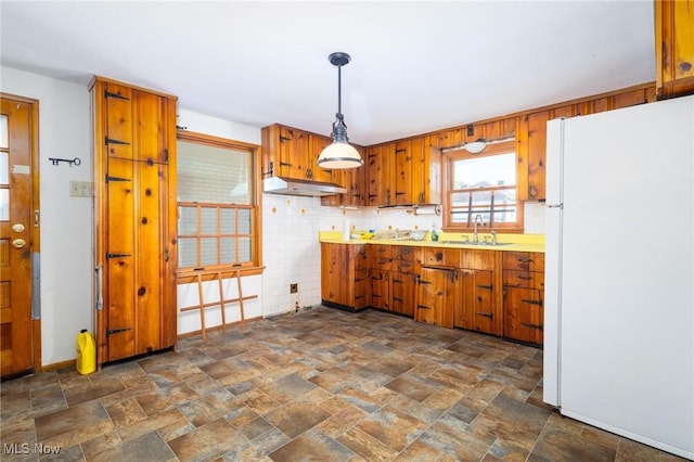 625 Henry St, Toronto, OH 43964 - kitchen featuring freestanding refrigerator, under cabinet range hood, brown cabinets, and light countertops
