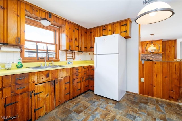 625 Henry St, Toronto, OH 43964 - kitchen with freestanding refrigerator, a sink, backsplash, and dark stone finish floors