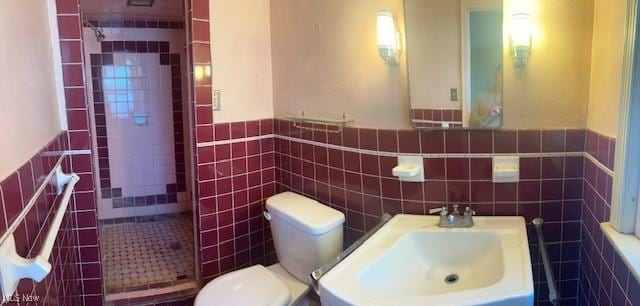 1081 Carver Rd, Cleveland Heights, OH 44112 - full bathroom with tile walls, toilet, a sink, a tile shower, and wainscoting
