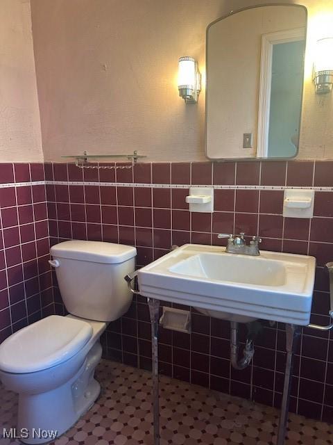1081 Carver Rd, Cleveland Heights, OH 44112 - half bath featuring tile walls, toilet, and a wainscoted wall