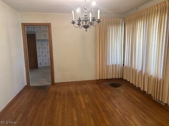 1081 Carver Rd, Cleveland Heights, OH 44112 - empty room with a chandelier, wood finished floors, and baseboards