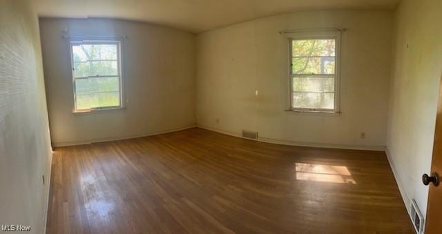 1081 Carver Rd, Cleveland Heights, OH 44112 - spare room with wood finished floors, healthy amount of natural light, baseboards, and lofted ceiling