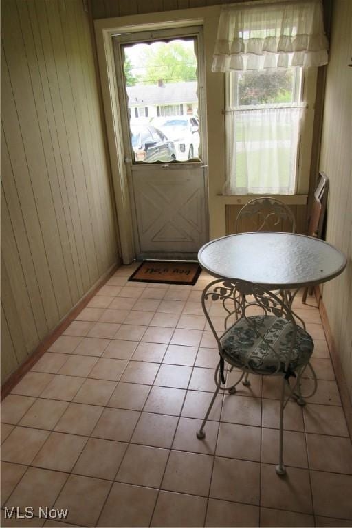 2313 W 13th St, Ashtabula, OH 44004 - doorway to outside featuring wooden walls and light tile patterned floors