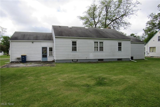 2313 W 13th St, Ashtabula, OH 44004 - back of house featuring a lawn and roof with shingles