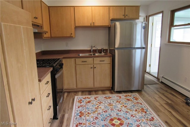3318 Avon Blvd, Ashtabula, OH 44004 - kitchen featuring freestanding refrigerator, a sink, gas range, under cabinet range hood, and light wood-style floors