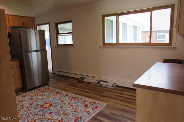 3318 Avon Blvd, Ashtabula, OH 44004 - kitchen featuring freestanding refrigerator, healthy amount of natural light, wood finished floors, and a baseboard radiator