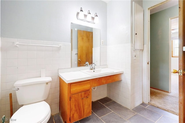 2920 Linda Way, Steubenville, OH 43952 - bathroom featuring tile walls, tile patterned flooring, a sink, toilet, and a wainscoted wall
