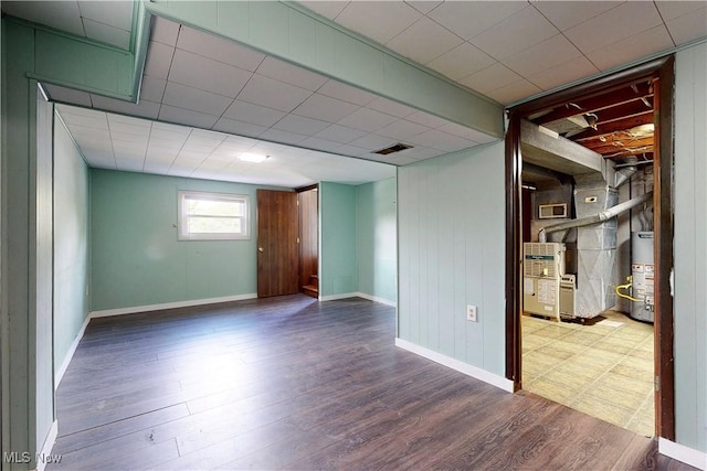 2920 Linda Way, Steubenville, OH 43952 - empty room with wood finished floors, baseboards, gas water heater, and heating unit