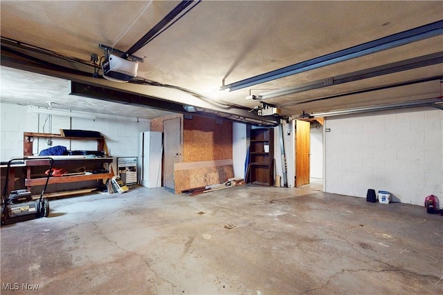 2920 Linda Way, Steubenville, OH 43952 - garage featuring a garage door opener and concrete block wall