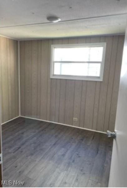 311 4th St, Beverly, OH 45714 - unfurnished room with wood finished floors and wooden walls