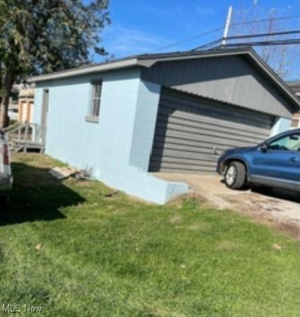 311 4th St, Beverly, OH 45714 - view of side of property with a lawn and stucco siding
