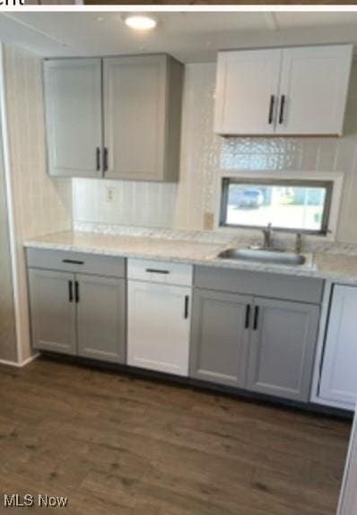 311 4th St, Beverly, OH 45714 - kitchen with dark wood-style flooring, light countertops, a sink, and gray cabinets