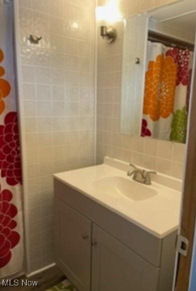 311 4th St, Beverly, OH 45714 - bathroom with vanity, tile walls, and curtained shower