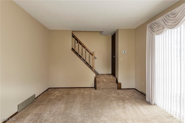 6533 Engle Rd, Brook Park, OH 44142 - empty room featuring light carpet, stairs, and baseboards
