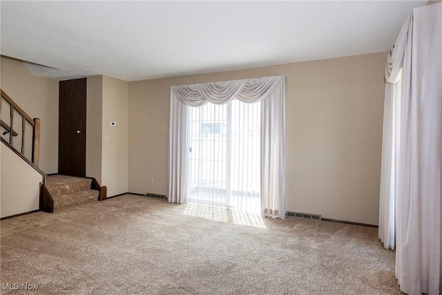 6533 Engle Rd, Brook Park, OH 44142 - unfurnished living room featuring carpet flooring, stairway, and baseboards