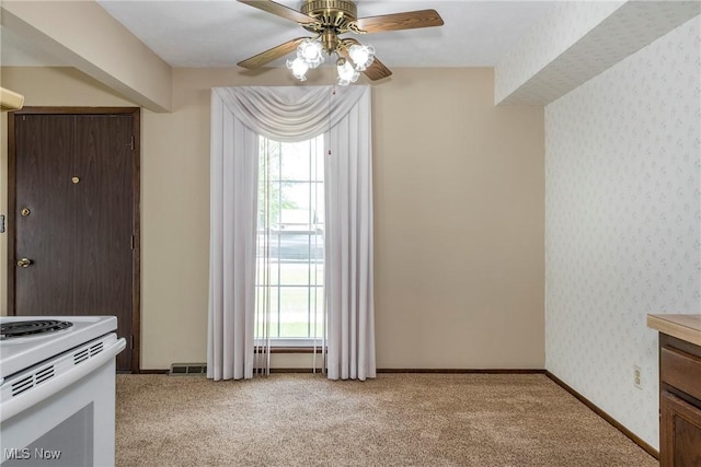 6533 Engle Rd, Brook Park, OH 44142 - unfurnished dining area with healthy amount of natural light, a ceiling fan, light carpet, and wallpapered walls