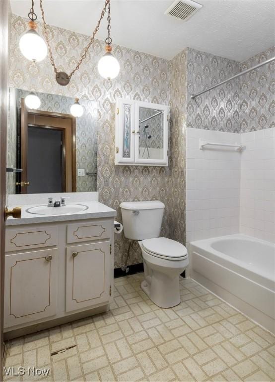 6533 Engle Rd, Brook Park, OH 44142 - bathroom with wallpapered walls, toilet, vanity, and bathing tub / shower combination