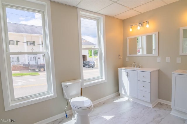 207 W Main St, Saint Clairsville, OH 43950 - bathroom with vanity, toilet, baseboards, a drop ceiling, and marble look tile flooring